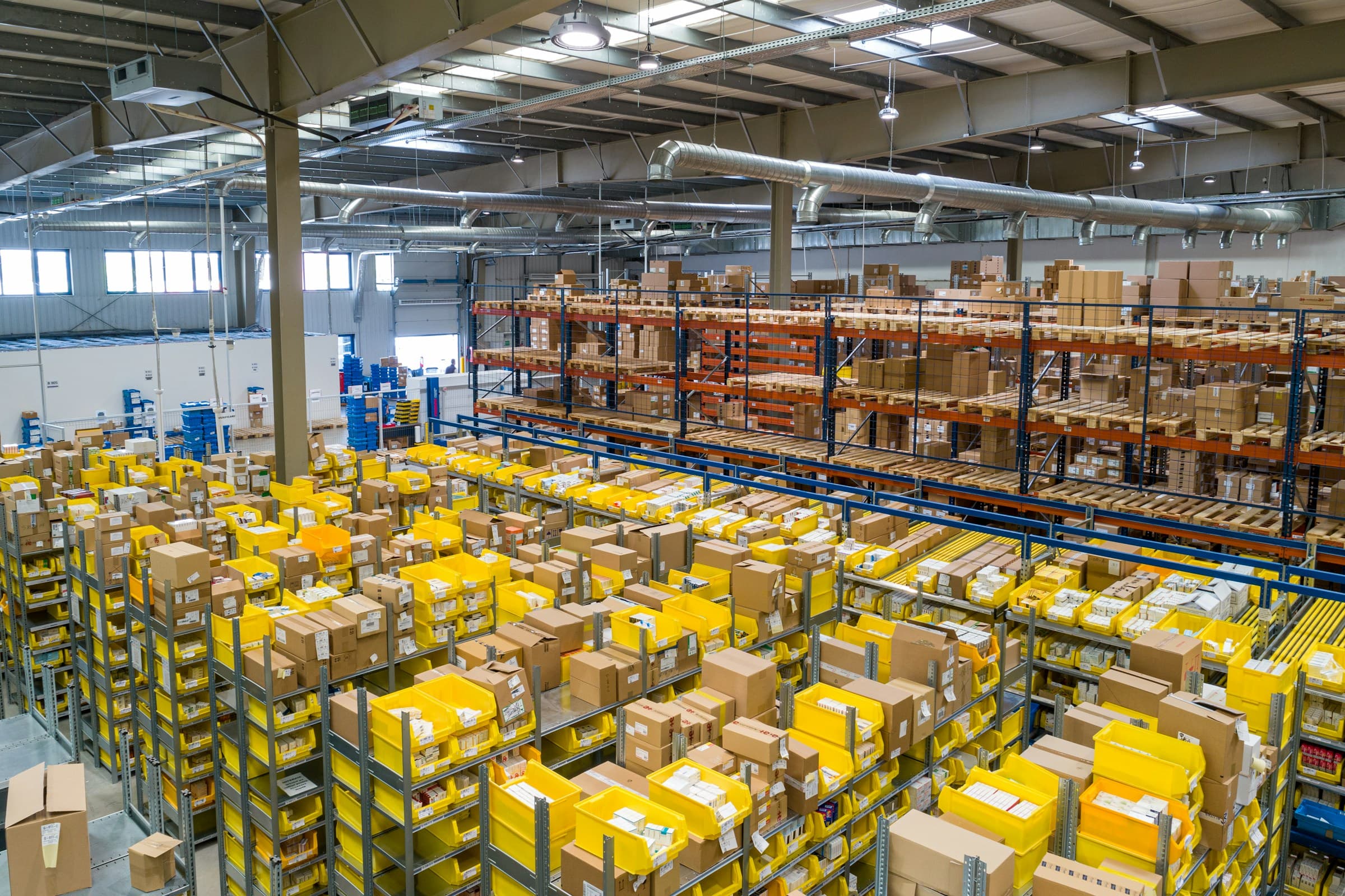 Organised warehouse racking with bins and palletised goods
