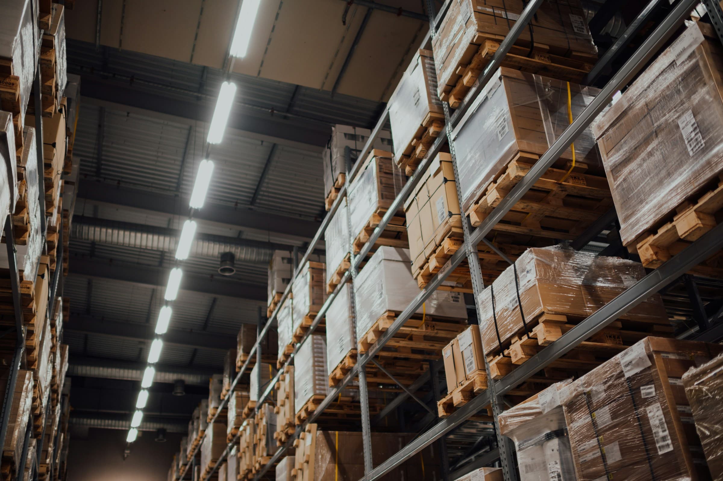 Warehouse operative in a hard hat checking stock