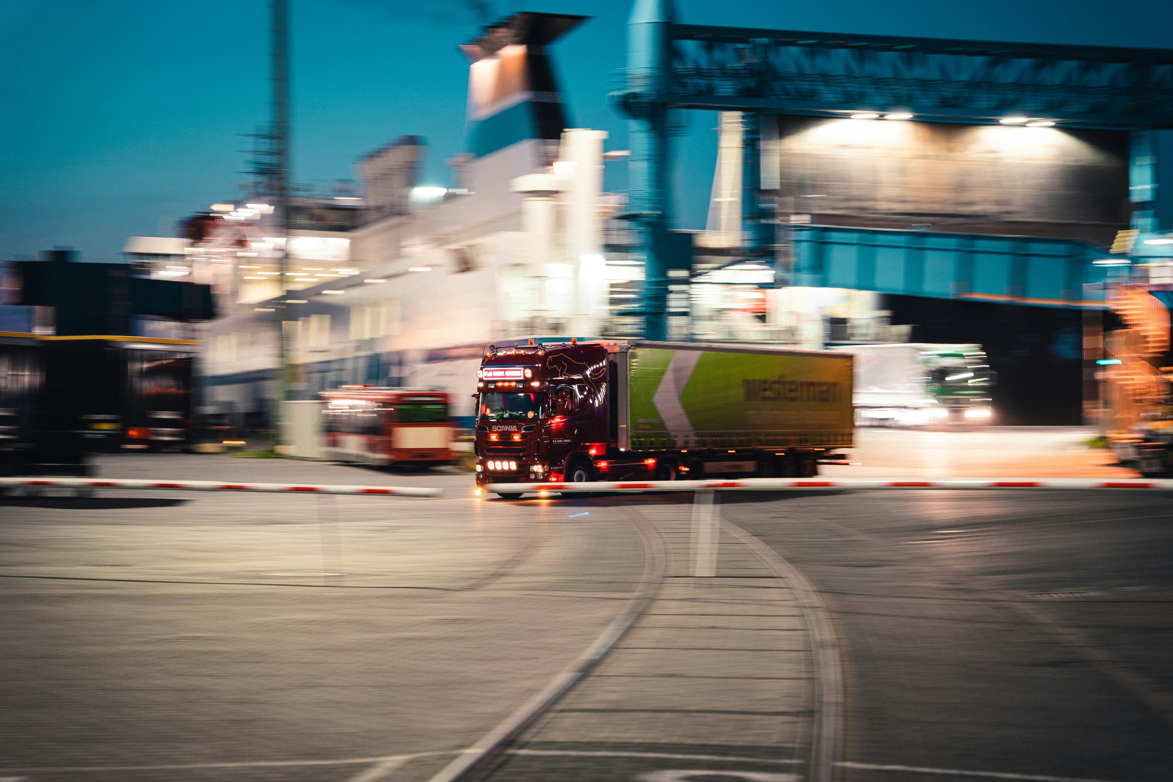 Professional HGV truck travelling on a UK motorway at dusk